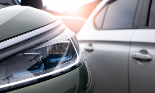 Close,Up,View,Of,Modern,Car,Headlight,With,Sunbeams.,Traffic