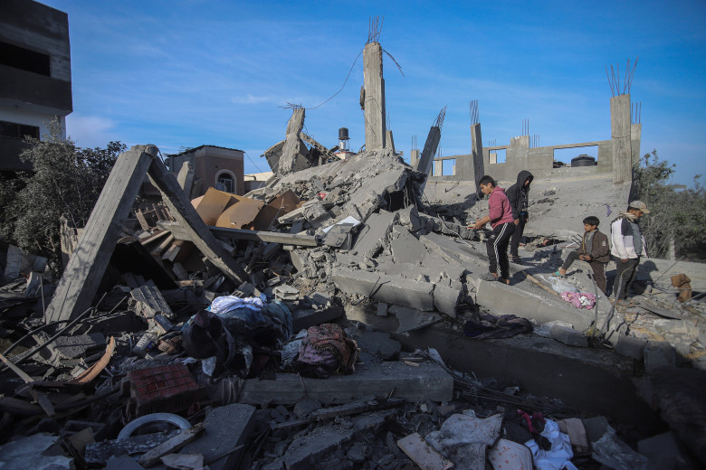 People inspect the destroyed house of the Al bayomi family in Al Nusairat refugee camp, central Gaza