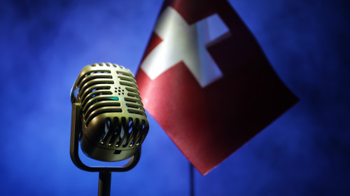 Microphone,On,A,Background,Of,A,Blurry,Flag,Of,Switzerland