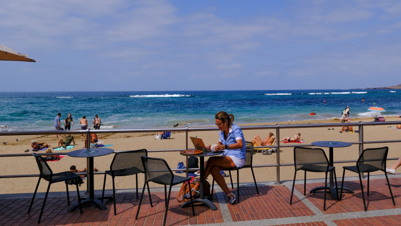 A,Man,Working,Using,Mobile,Phone,And,Laptop,Computer,In