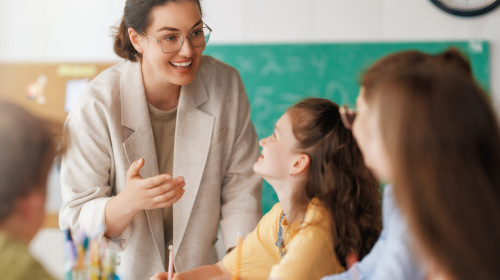 Happy,Kids,And,Teacher,At,School.,Woman,And,Children,Are