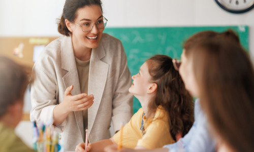 Happy,Kids,And,Teacher,At,School.,Woman,And,Children,Are