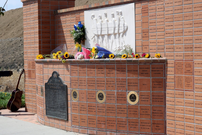 Fans lay flowers and sing at The Beach Boys' memorial after the death of Brian Wilson, aged 82