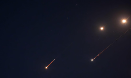 JERUSALEM - JUNE 14: Debris of missiles fired from Iran towards the territory of Israel leave trails in the night sky after being intercepted on June 14, 2025 in Jerusalem. Iran launched a retaliatory missile strike on Israel starting late on June 13, af