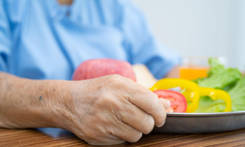 Asian senior or elderly old lady woman patient eating breakfast vegetable healthy food with hope and happy while sitting and hungry on bed in hospital