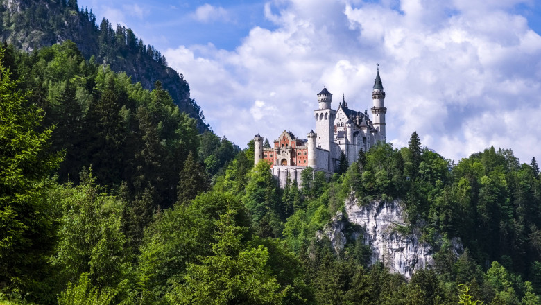 Castle Neuschwanstein, located on top of a rock, surrounded by deep forrest. Hohenschwangau Bavaria Germany FB_2024_2690