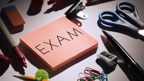 Exam against students table with school supplies