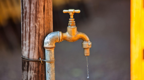 water shortages in africa, tap in the yard outside in a village in Botswana