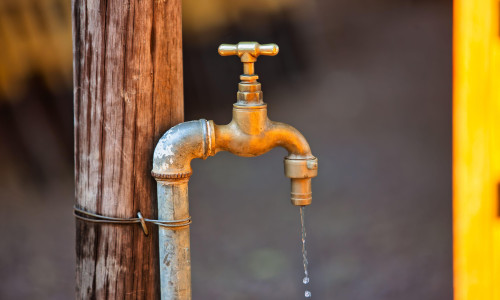 water shortages in africa, tap in the yard outside in a village in Botswana