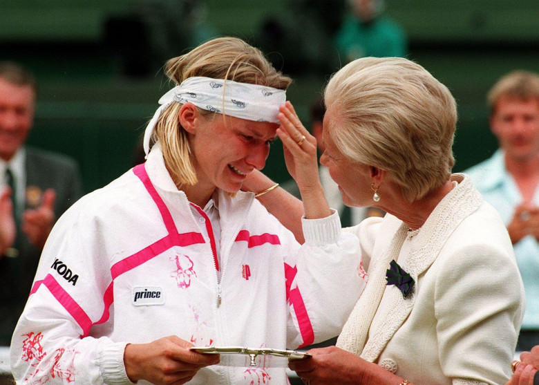 File photo dated 3/7/1993 of the Duchess of Kent consoling Jana Novotna as she presents her with the runner-up trophy on centre court at Wimbledon after she lost 6-7, 6-1, 4-6 to defending champion Steffi Graf. The Duchess of Kent, who was married to the