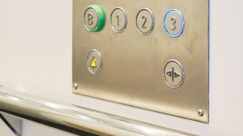 Closeup of metal buttons in an elevator background