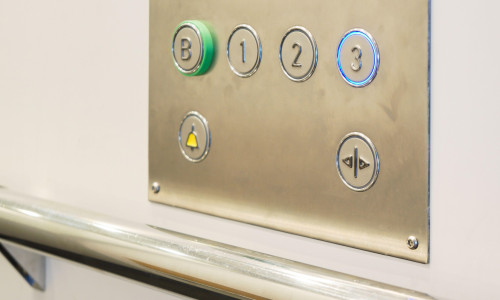 Closeup of metal buttons in an elevator background