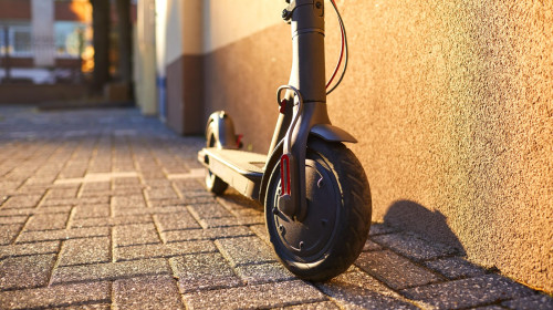 Electric scooter on a background of a wall