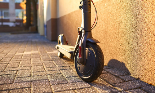 Electric scooter on a background of a wall