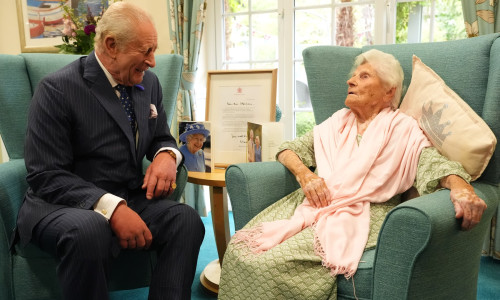 King Charles III meets world's oldest person