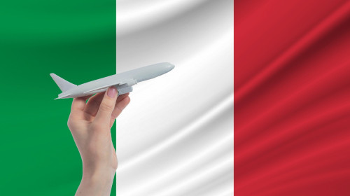 Airplane in hand with national flag of Italy Travel to Italy.