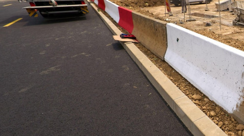 Bucharest, Romania. 20th Jun, 2025: Workers paint the road markings on the new road passing as a bypass route through the reconstruction site of the concrete slab covering the Dambovita River in Unirii Square. Severely degraded, the 350-meter concrete sla