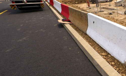 Bucharest, Romania. 20th Jun, 2025: Workers paint the road markings on the new road passing as a bypass route through the reconstruction site of the concrete slab covering the Dambovita River in Unirii Square. Severely degraded, the 350-meter concrete sla