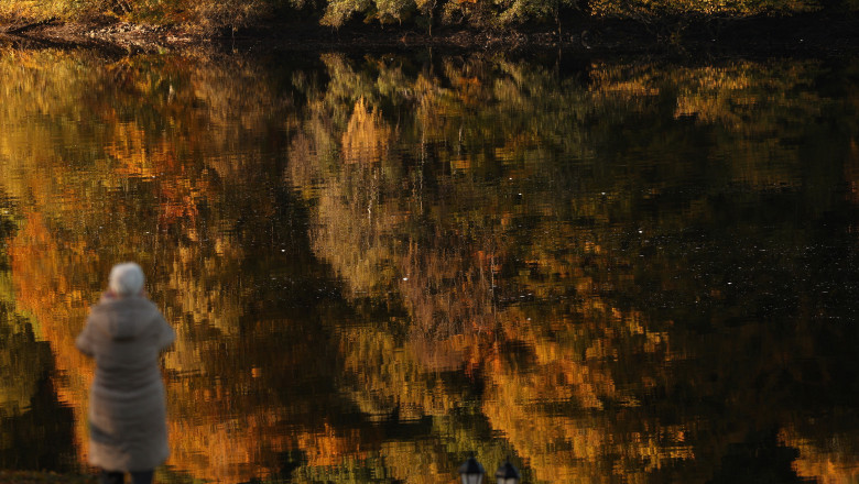 Autumnal foliage is reflected on Loch Faskally, in Pitlochry