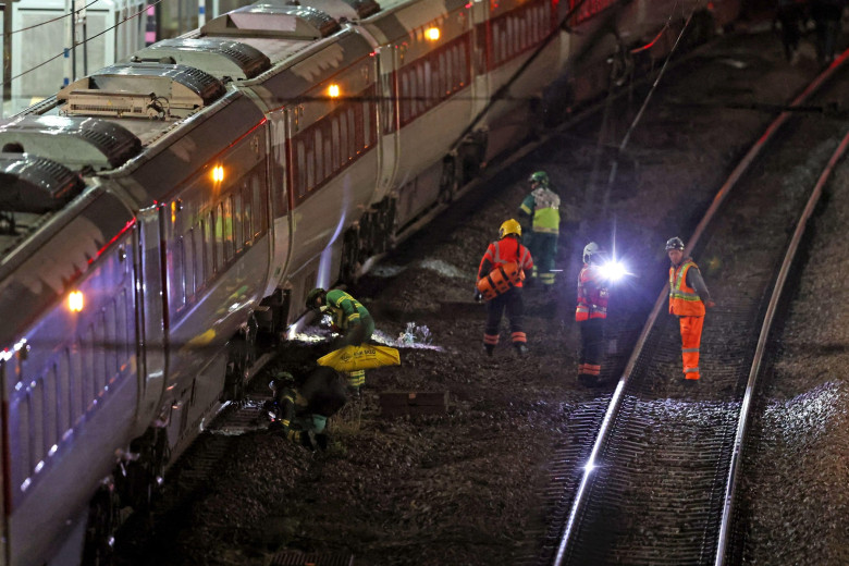 Emergency responder on the tracks by the train at Huntingdon station in Cambridgeshire, after a number of people were stabbed. Two people have been arrested after British Transport Police were called to the incident on a train. Picture date: Saturday Nove