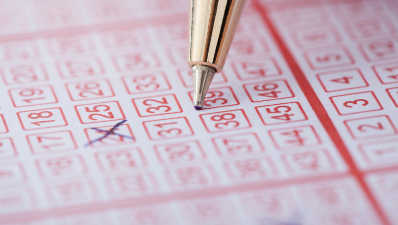 Closeup of pen marking numbers on lottery ticket