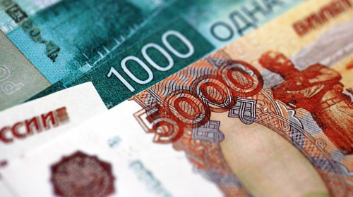 Russian ruble money bills banknotes lies in big pile on table close up. Concept of finances and business in Russian Federation