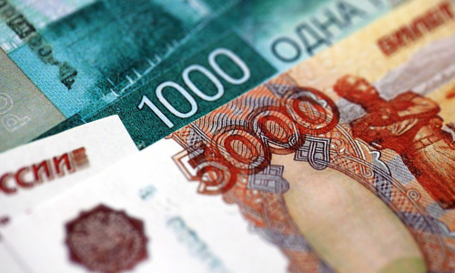 Russian ruble money bills banknotes lies in big pile on table close up. Concept of finances and business in Russian Federation