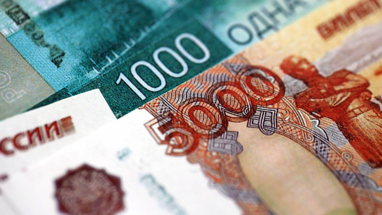 Russian ruble money bills banknotes lies in big pile on table close up. Concept of finances and business in Russian Federation