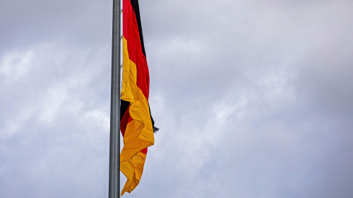 German flag close-up against a cloudy sky