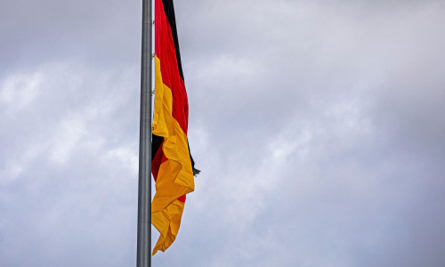 German flag close-up against a cloudy sky