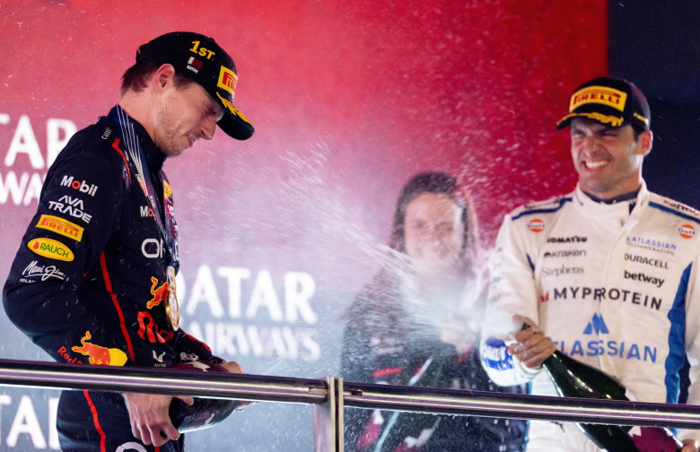 DOHA - Max Verstappen (Red Bull Racing) on the podium with Carlos Sainz (Williams) and Hannah Schmitz (Red Bull Racing's chief strategy engineer) after winning the Qatar Grand Prix at the Lusail International Circuit. ANP SANDER KONING