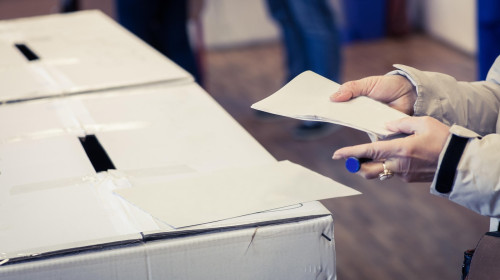 A person casts her ballot during voting for parliamentary elections at a polling station in Bucharest, Romania.