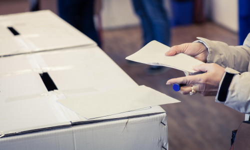 A person casts her ballot during voting for parliamentary elections at a polling station in Bucharest, Romania.