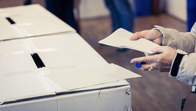 A person casts her ballot during voting for parliamentary elections at a polling station in Bucharest, Romania.