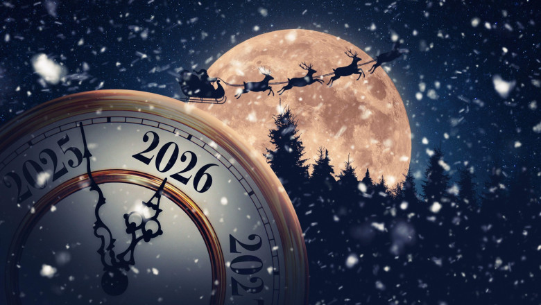 Magical holiday time transition to 2026. A snowy, New Year's Eve clock is set against a massive full moon with Santa Claus and his reindeer flying acr