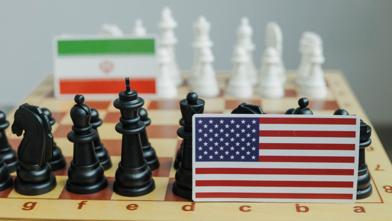 Flag of USA and a Iranian flag on chessboard. Conflict between those two countries.