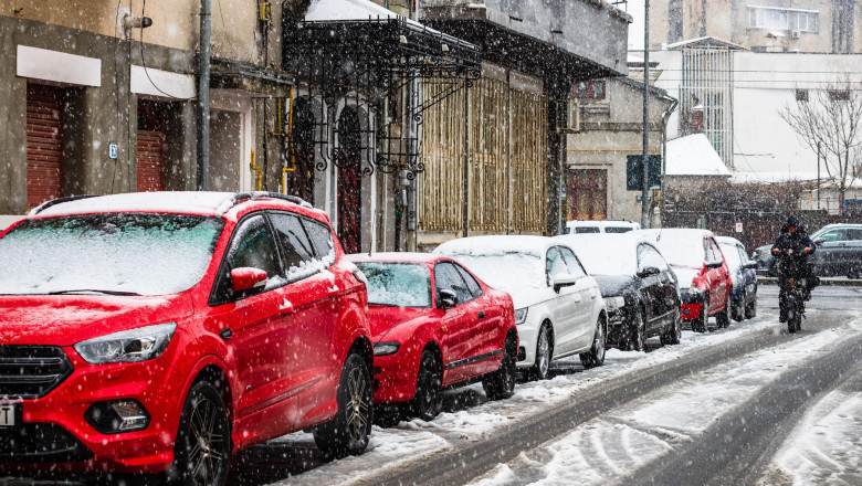 Snowing on cars in the morning, snow on street in Bucharest, Romania, 2021