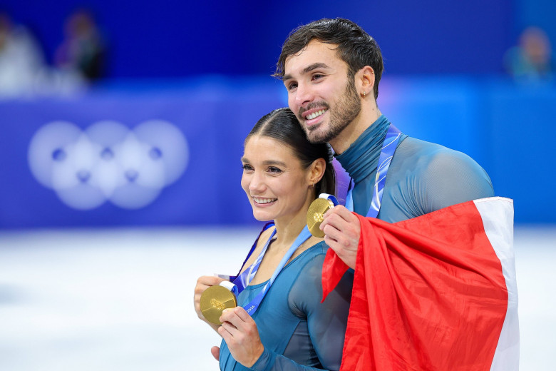 MILAN, ITALY - FEBRUARY 11: Gold medalists Laurence Fournier Beaudry and Guillaume Cizeron of Team France celebrate duri