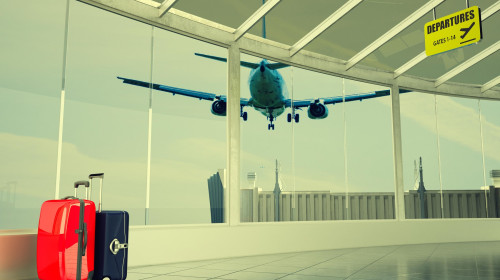 passenger plane flying over airport terminal - traveling luggage at airport terminal