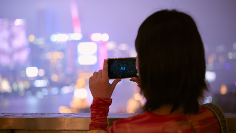 Woman capturing cityscape on AI phone at night with vibrant lights in the background. Shanghai, China