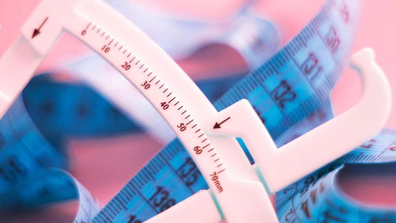 Fat caliper and measuring tape used to measure waistline, bodyfat levels for fitness and obesity checks.