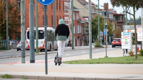 Young man with hoody on an e step scooter in Evere, Brussels, Belgium 21 SEP 2025