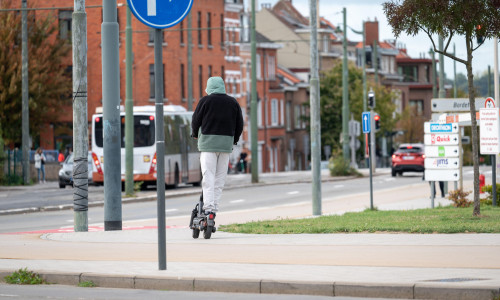 Young man with hoody on an e step scooter in Evere, Brussels, Belgium 21 SEP 2025