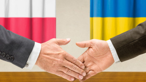 Representatives of Poland and Ukraine shake hands