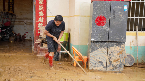 NANNING, CHINA - JULY 08: Flood-affected resident clears mud from his house on July 8, 2026 in Hengzhou, Nanning, Guangx