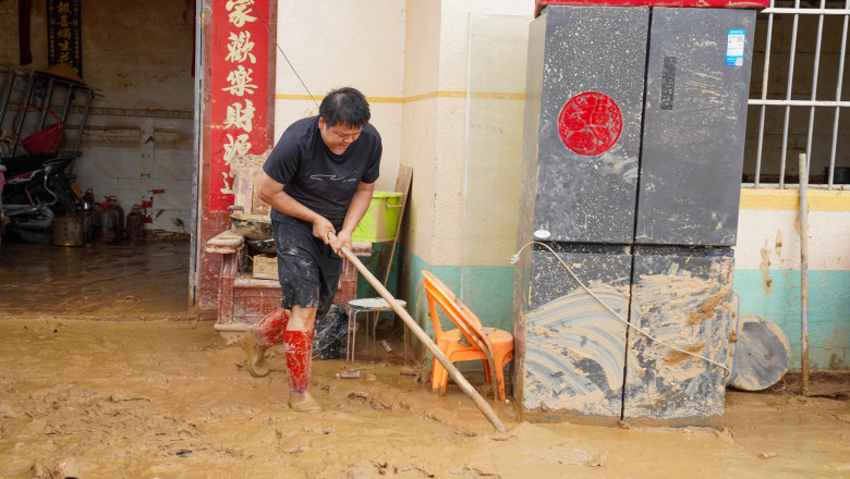NANNING, CHINA - JULY 08: Flood-affected resident clears mud from his house on July 8, 2026 in Hengzhou, Nanning, Guangx