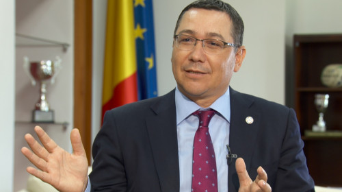 Victor Ponta arătând cu mâinile și zâmbind