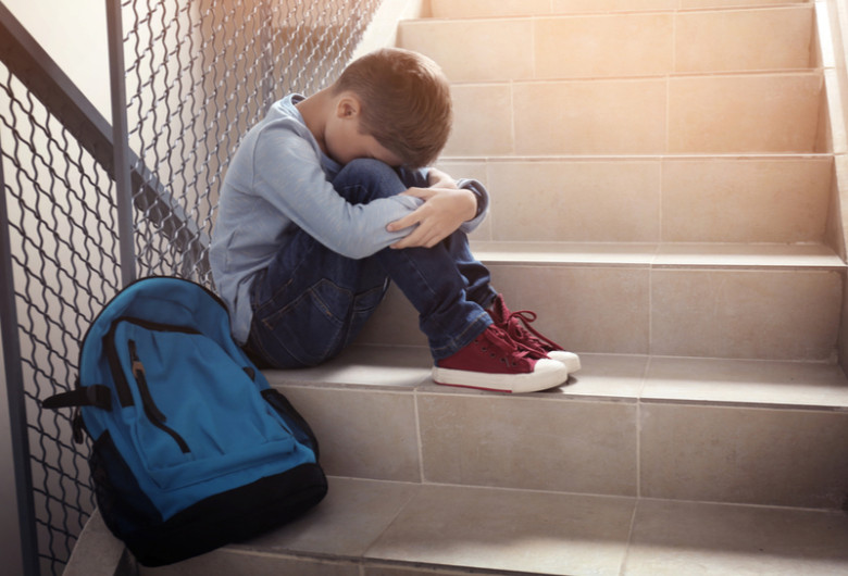 Elev pe scări, la școală, bătut, agresat, bullying, violență, copil cu ghiozdan