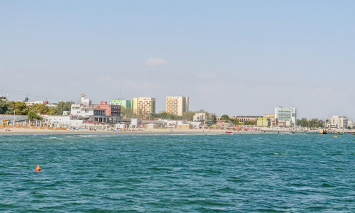 CONSTANTA, ROMANIA - SEPTEMBER 16, 2016: The Black Sea, seafront and seaside with blue water and gold sand, hotels.