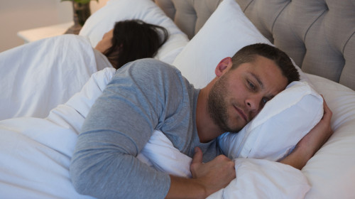 Angry couple avoiding each other in bedroom at home